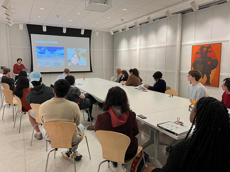 A group of people listening to a presentation